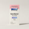 Sleep aid package with sheep illustration and 'Sandland' branding on a beige background