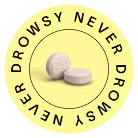 Two white pills on a yellow background with 'Never Drowsy' text.