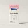 Supplement label with 'Sandland' branding on a beige background